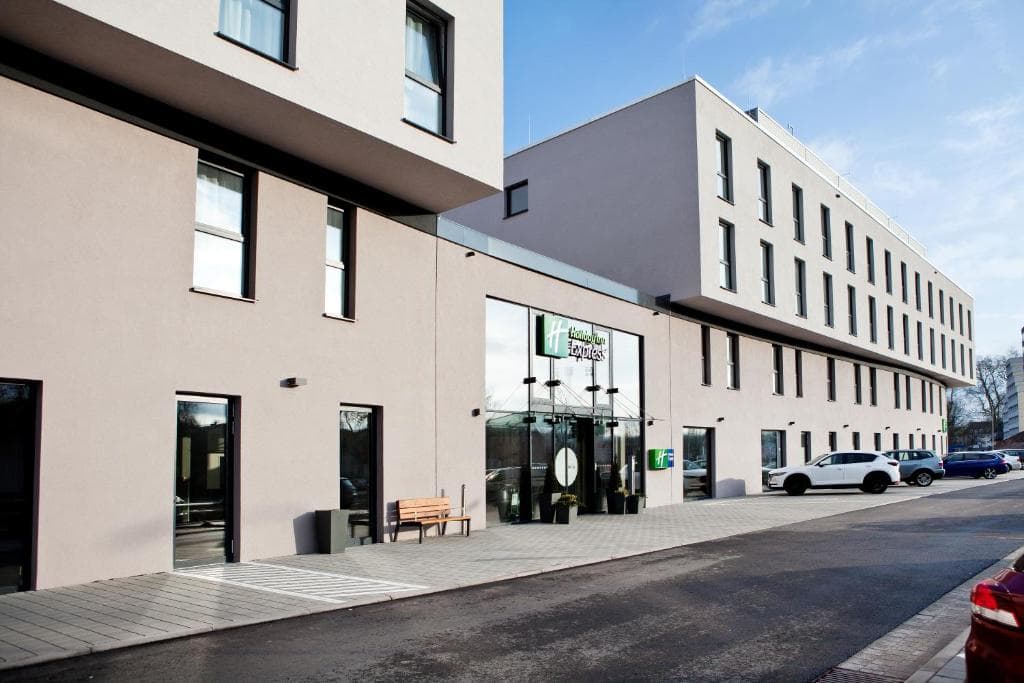 Holiday Inn Express hotel exterior with modern architecture and parked cars in Trier.