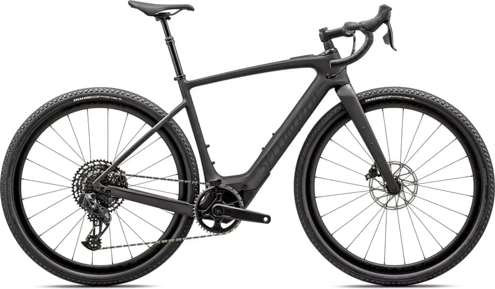 Matte black gravel e-bike with drop handlebars and knobby tires.