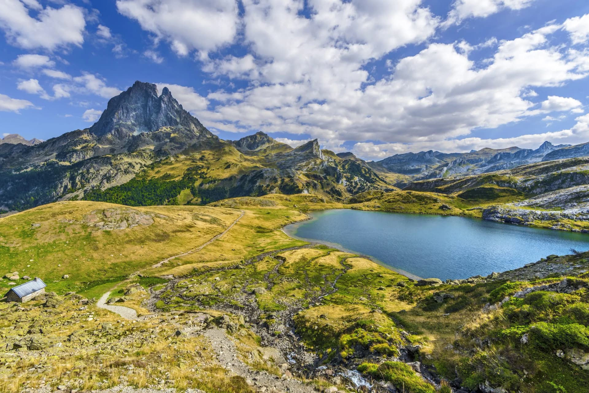Midi d'Ossau peak above Lake Roumassot in the French Atlantic Pyrenees in October.