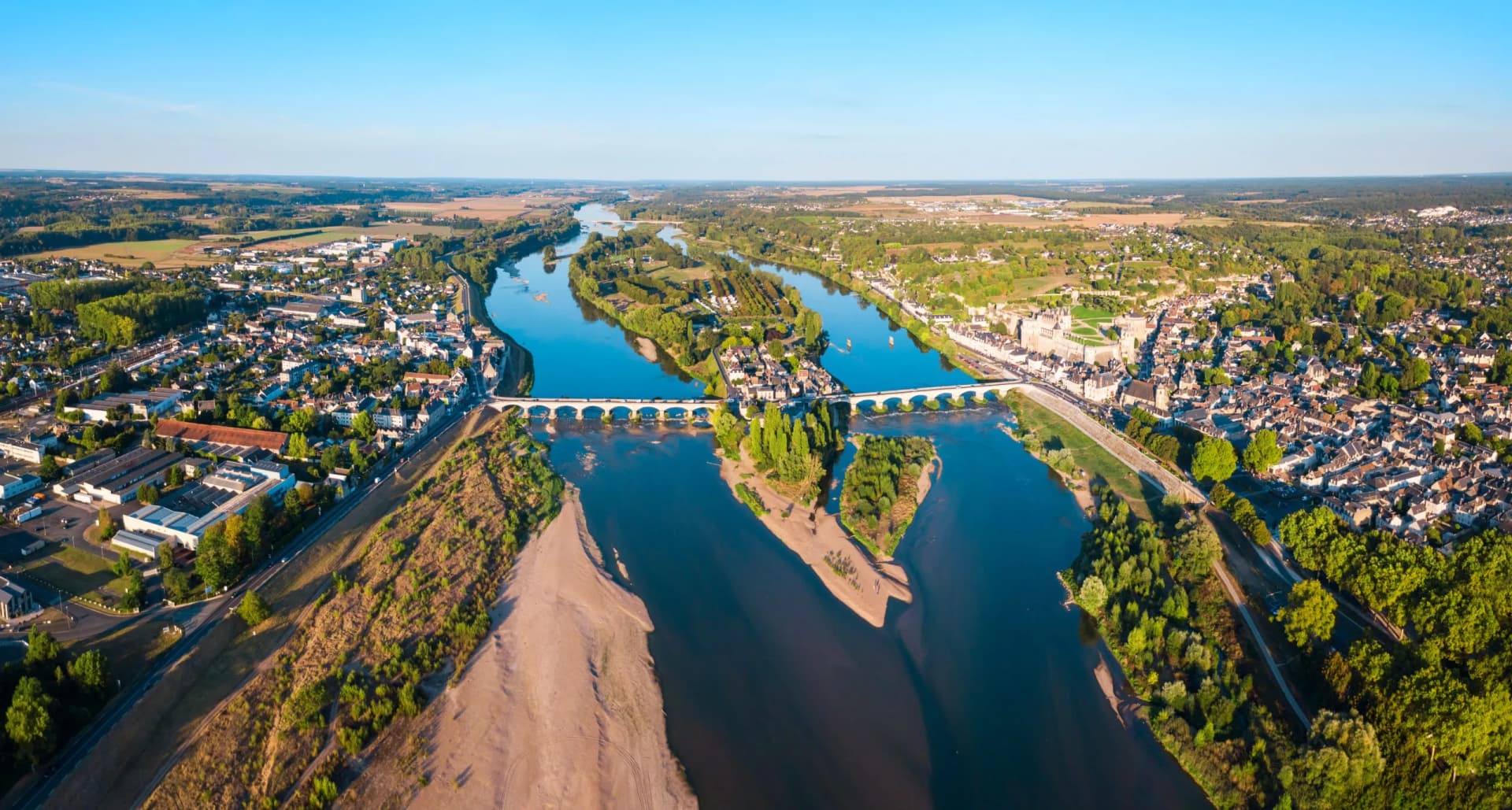 Aerial panoramic view of Château d'Amboise overlooking the Loire River and bridge in France.