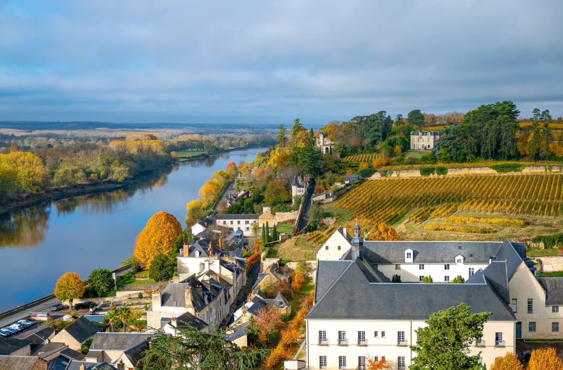 View of Chinon medieval town, Loire River, and autumn vineyards from the Royal Fortress.