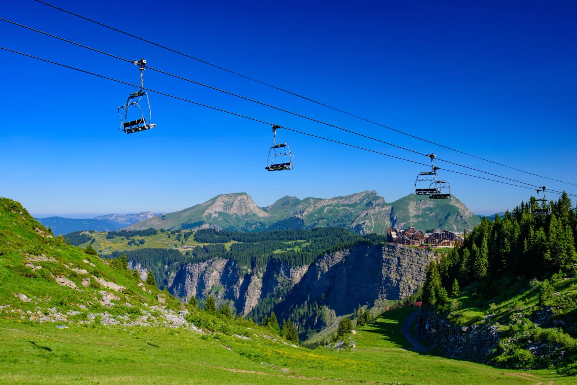 Empty chairlift over green summer mountains at Avoriaz resort in Portes du Soleil, France.