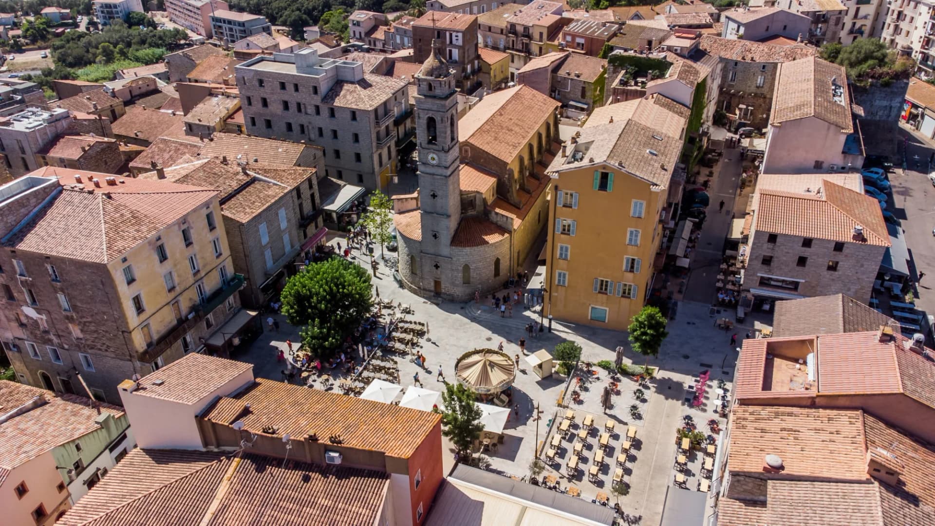 Aerial view of Place de la République, Porto Vecchio, Corsica, showing the Church of Saint John the Baptist.