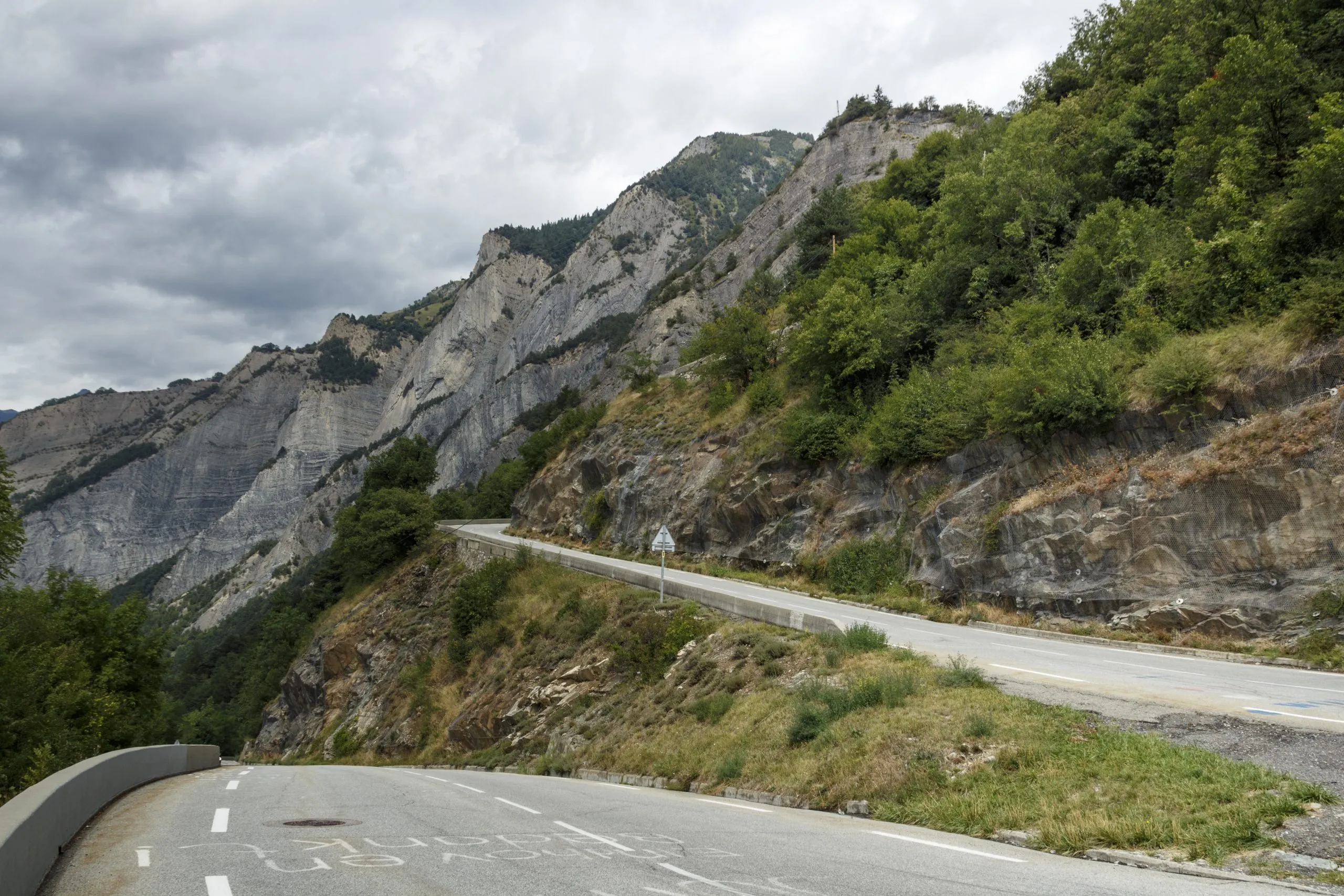 L'Alpe d'Huez, France - August 19, 2019: Ascent of the famous climb to L'Alpe d'Huez and itinerary of the Tour de France at bend 20